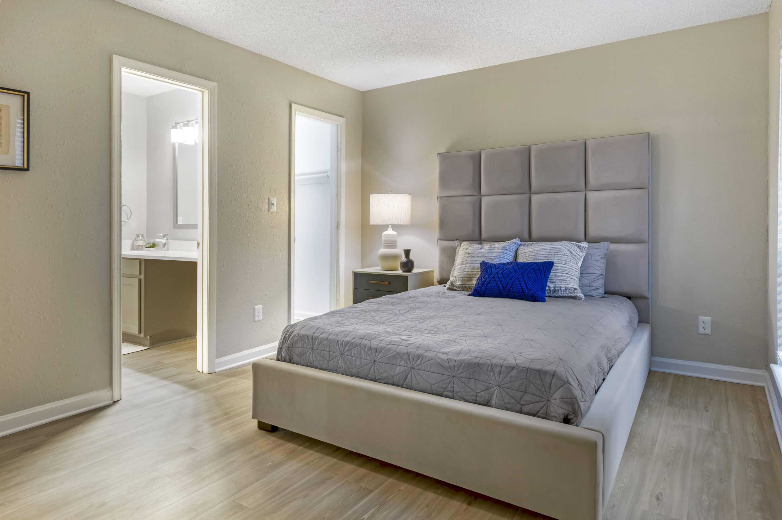 a bedroom with hardwood floors and a large bed at The  Sawyer