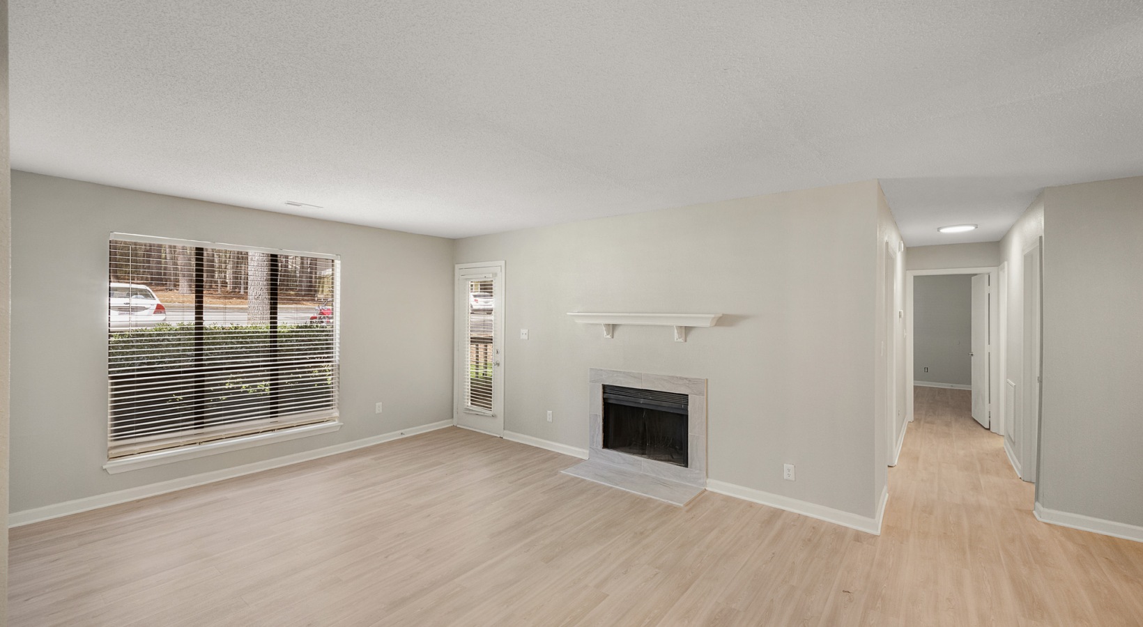 empty living room with hardwood floors and fireplace at The  Sawyer