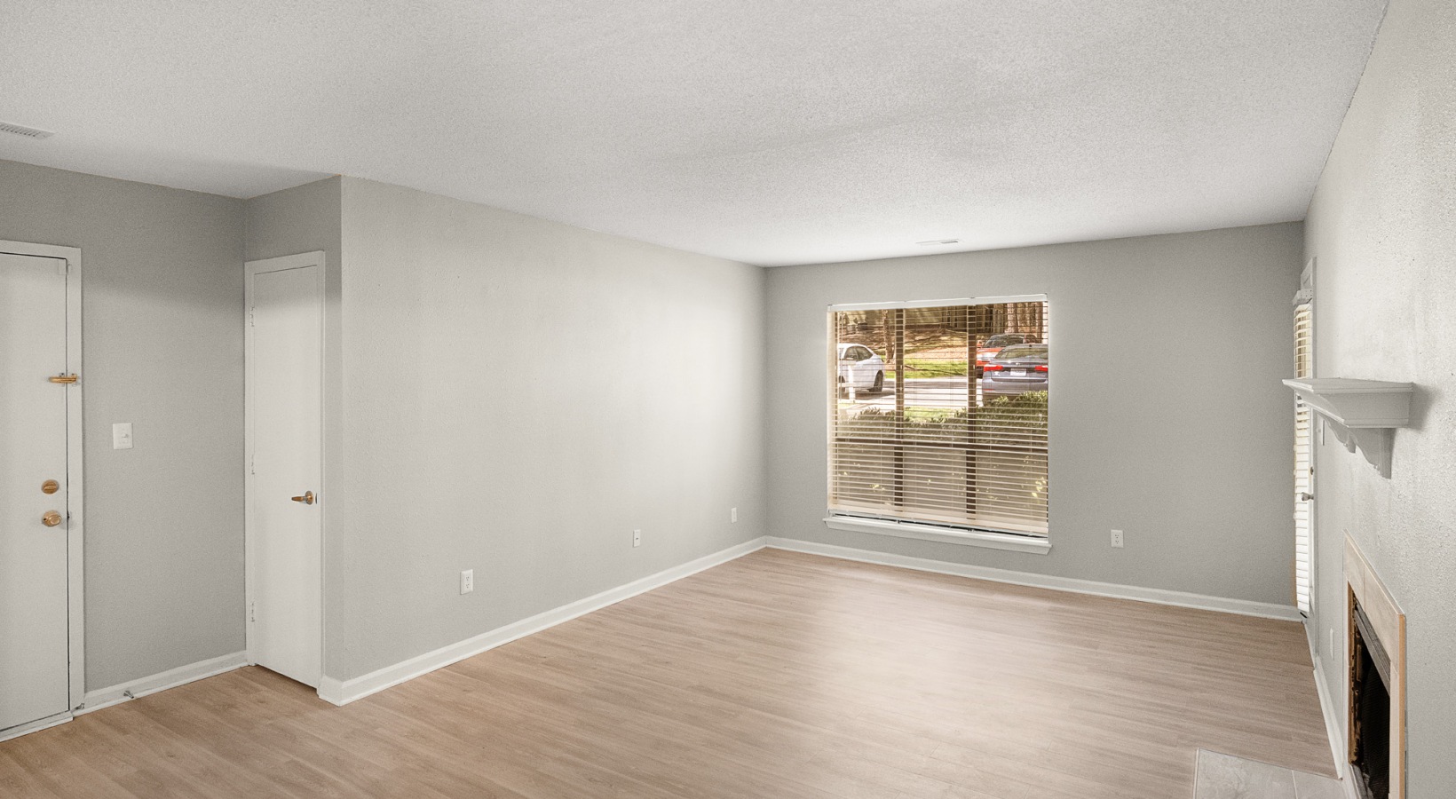 empty room with hardwood floors and a window at The  Sawyer