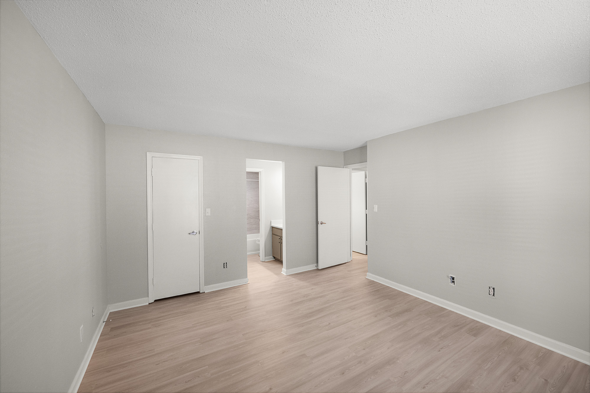 empty room with hardwood floors and white walls at The  Sawyer