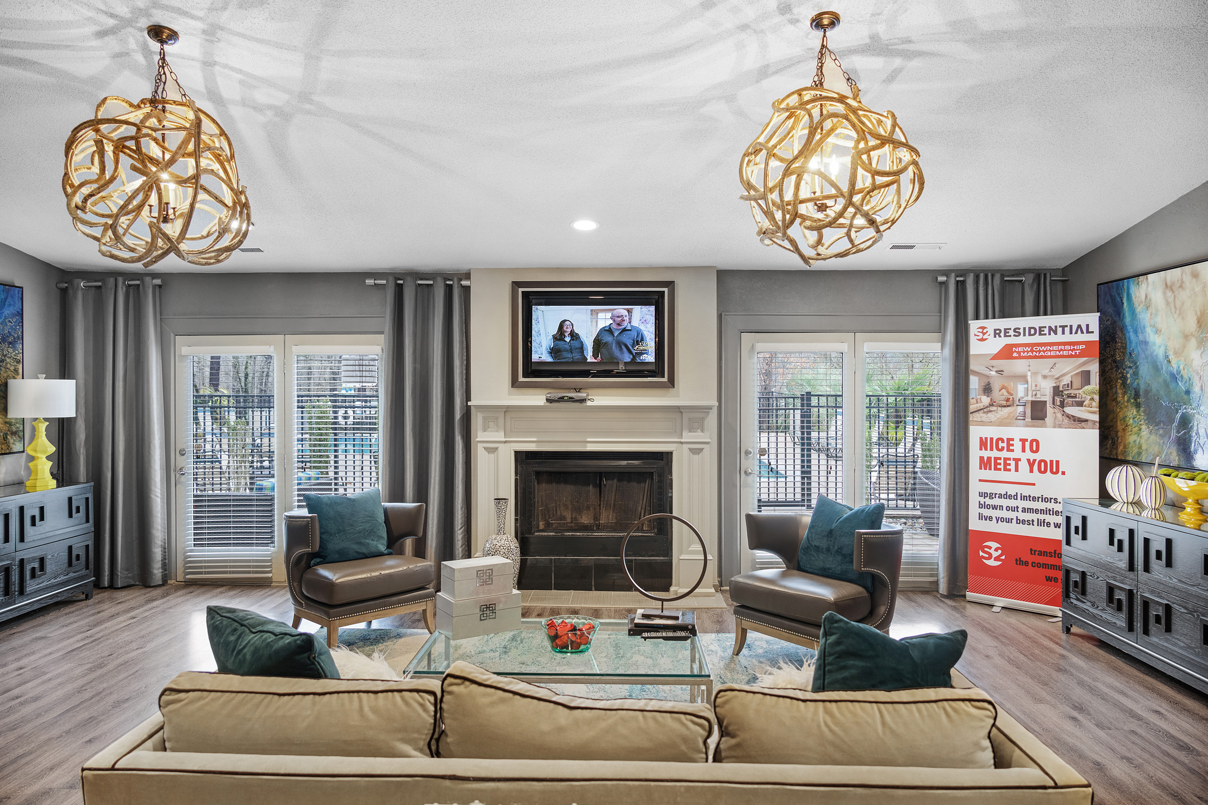 a living room with a fireplace and couches at The  Sawyer