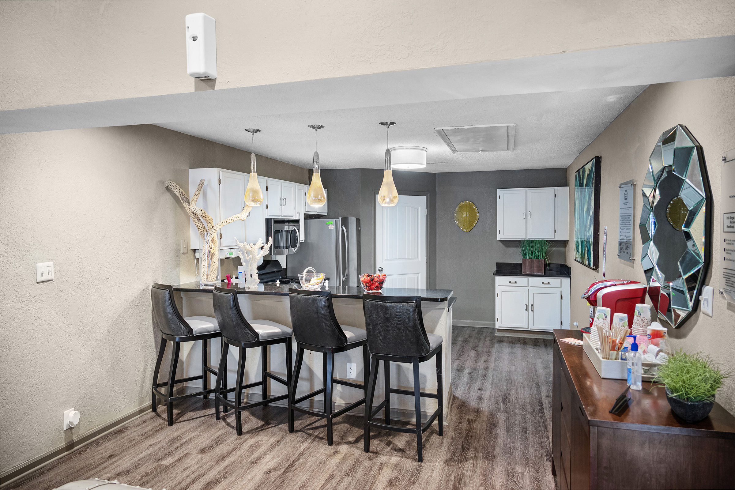 a kitchen with a bar and a dining area at The  Sawyer