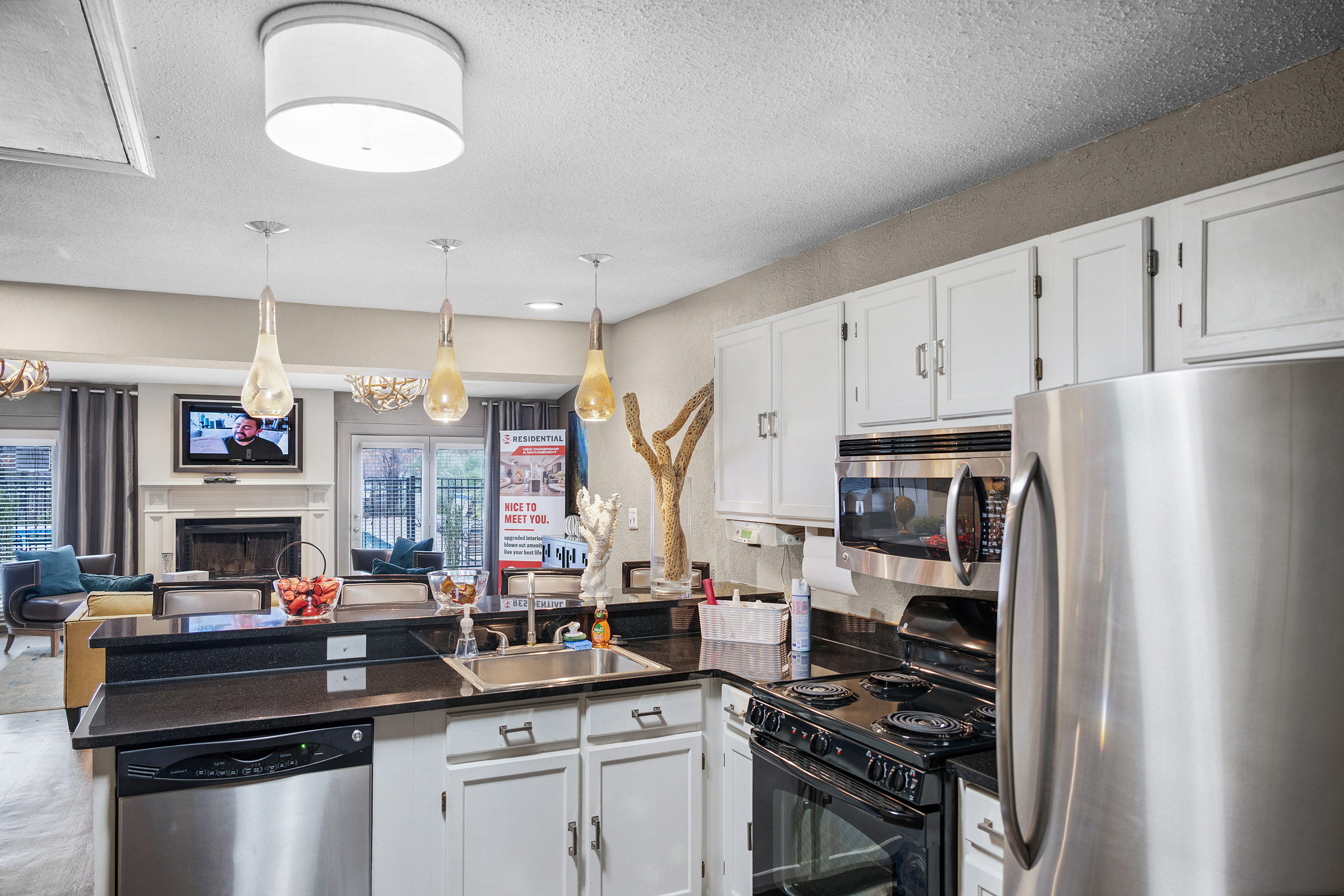 a kitchen with stainless steel appliances and a microwave at The  Sawyer