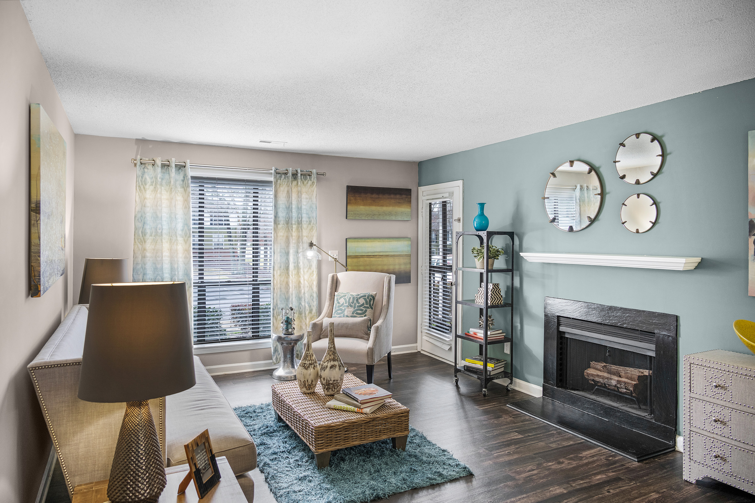 a living room with a fireplace and blue walls at The  Sawyer