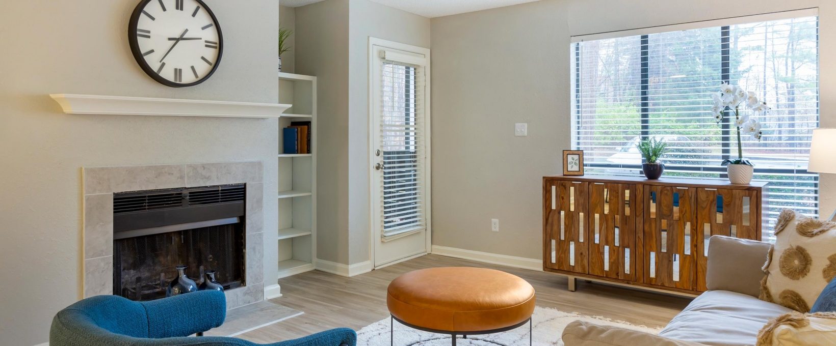 a living room with a fireplace and a clock at The  Sawyer