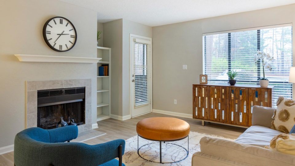 a living room with a fireplace and a clock at The  Sawyer