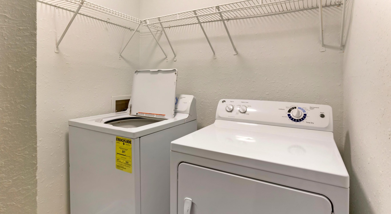 a washer and dryer in a small room at The  Sawyer