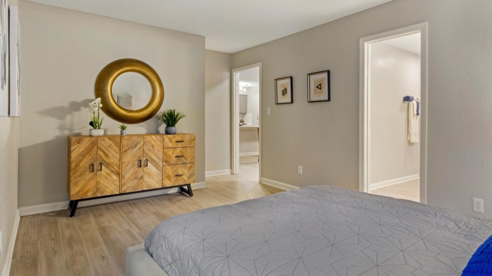 a bedroom with a large mirror and a dresser at The Sawyer