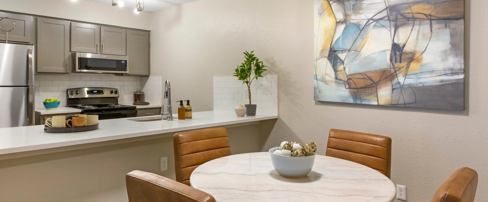 a kitchen and dining area with a large painting on the wall at The  Sawyer