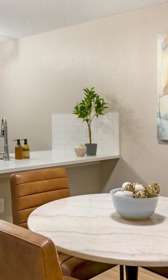 a kitchen and dining area with a large painting on the wall at The  Sawyer