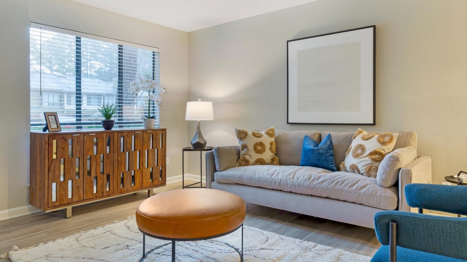 a living room with a couch, coffee table and chair at The Sawyer