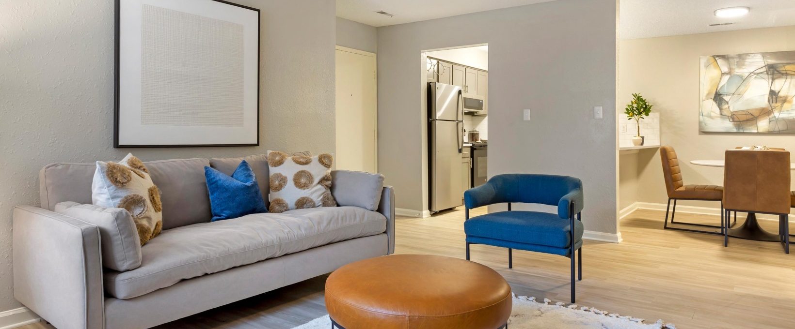 a living room with a couch, chair and ottoman at The Sawyer