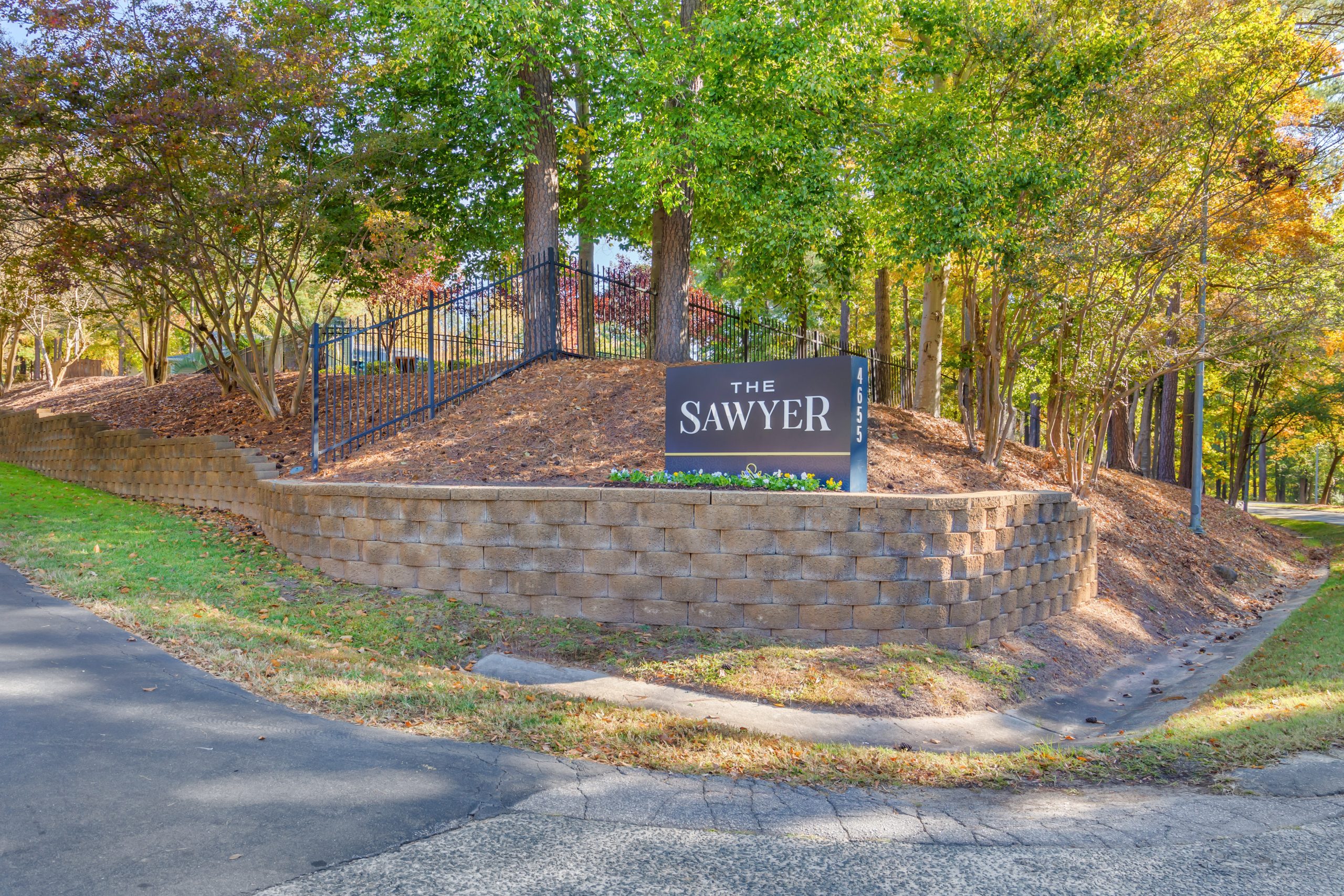the entrance to a residential neighborhood with a sign at The  Sawyer