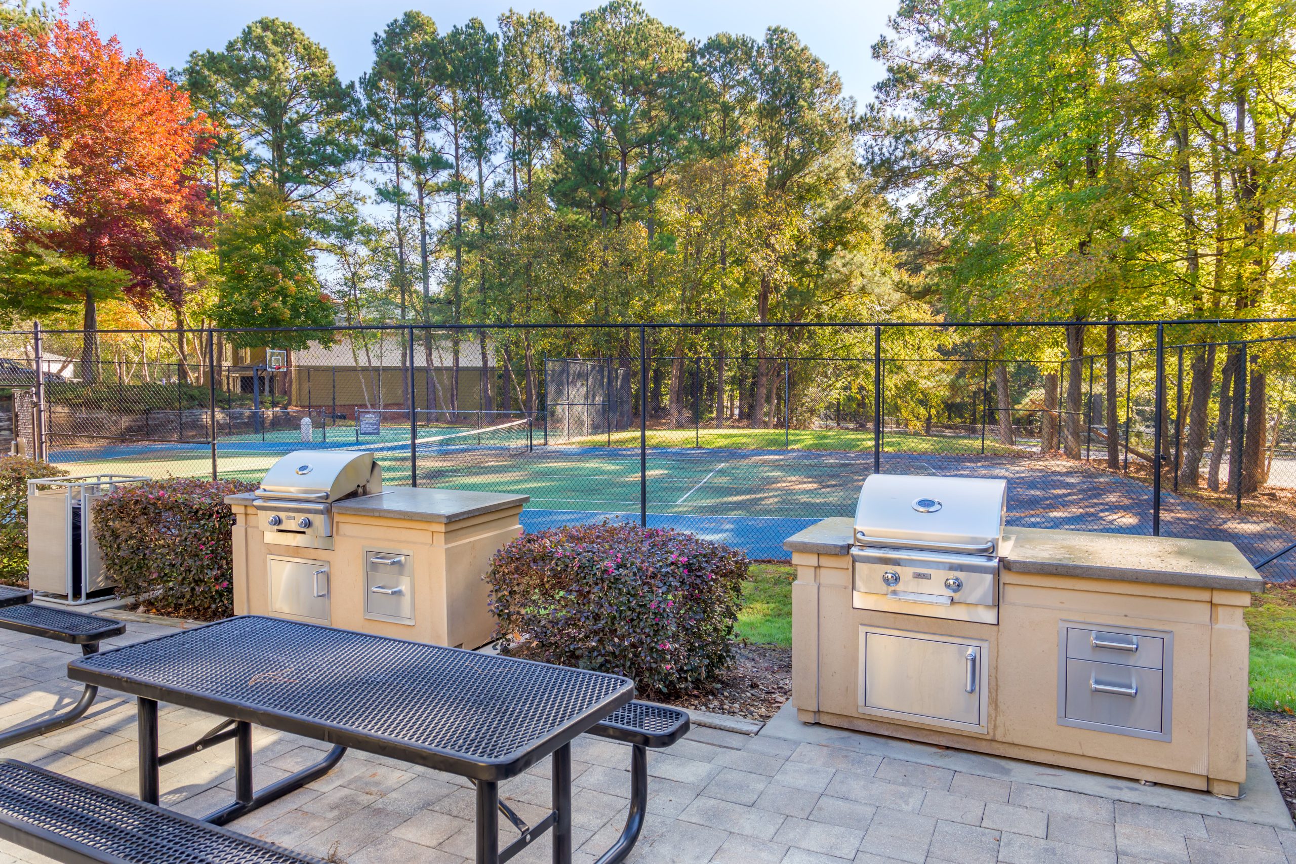 a grill and picnic table in the backyard of a home at The  Sawyer