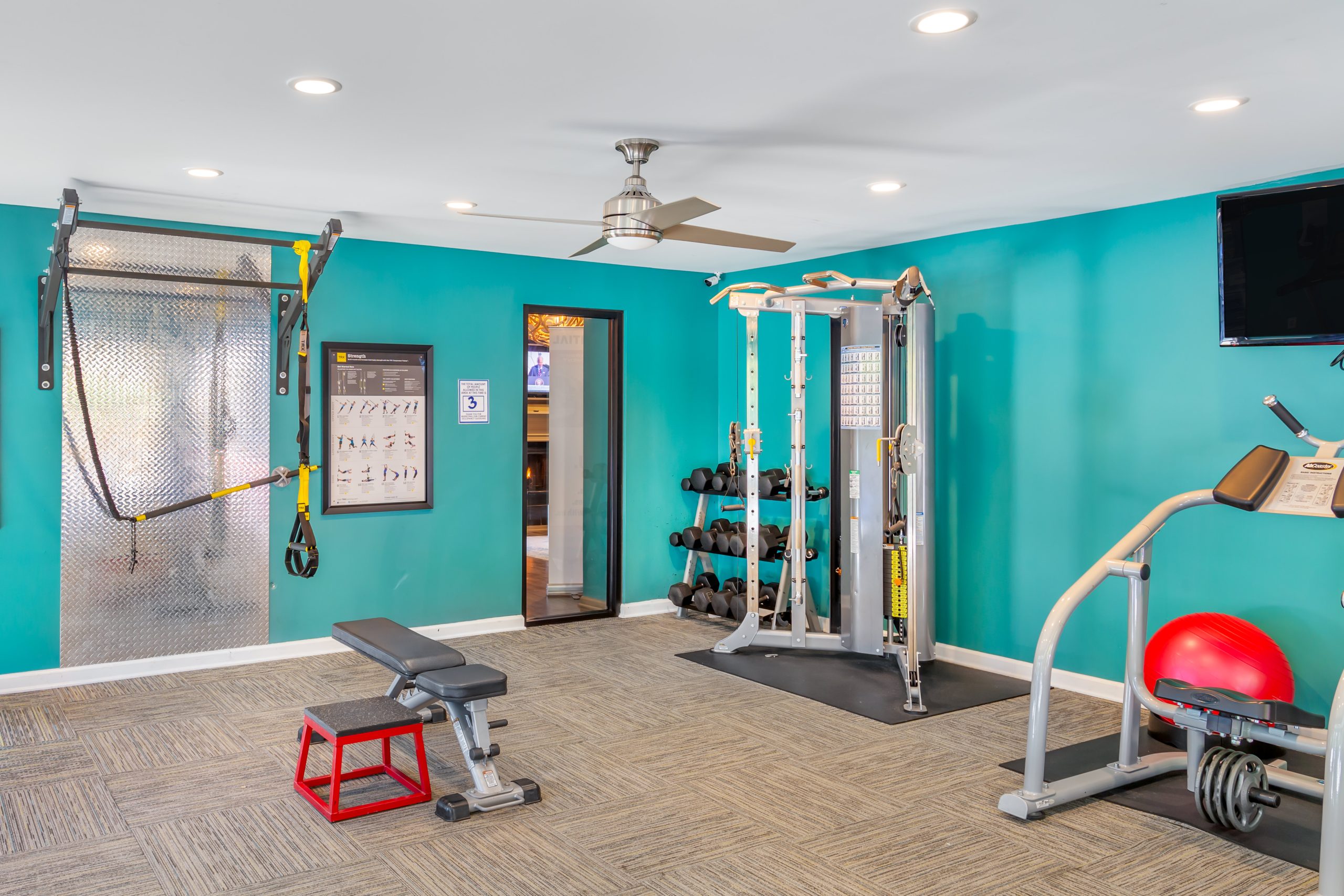 a gym room with exercise equipment and a television at The  Sawyer