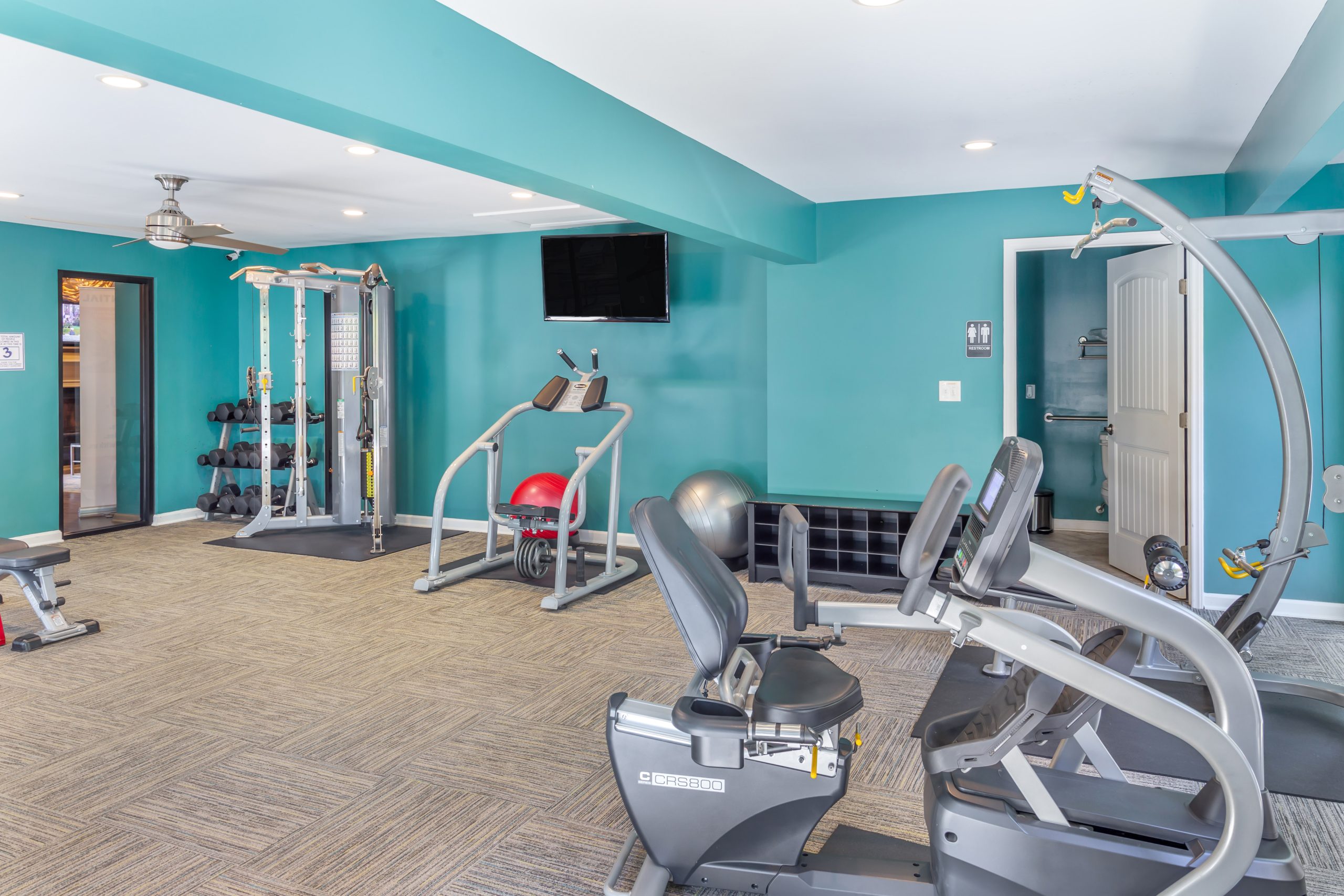 a gym room with exercise equipment and blue walls at The  Sawyer