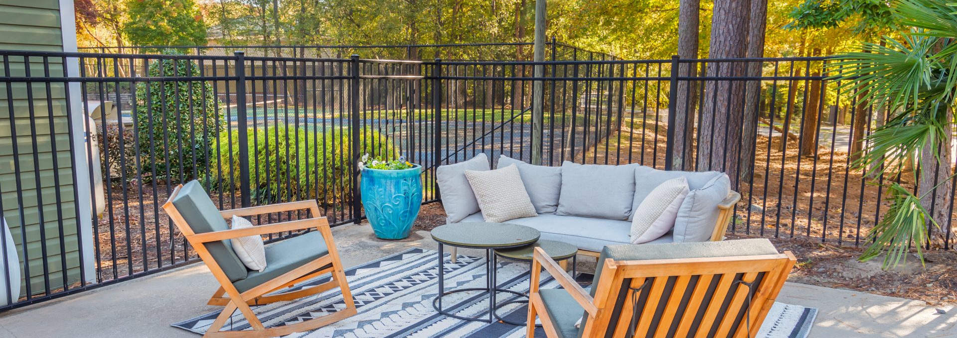 patio furniture and chairs in a fenced in yard at The  Sawyer