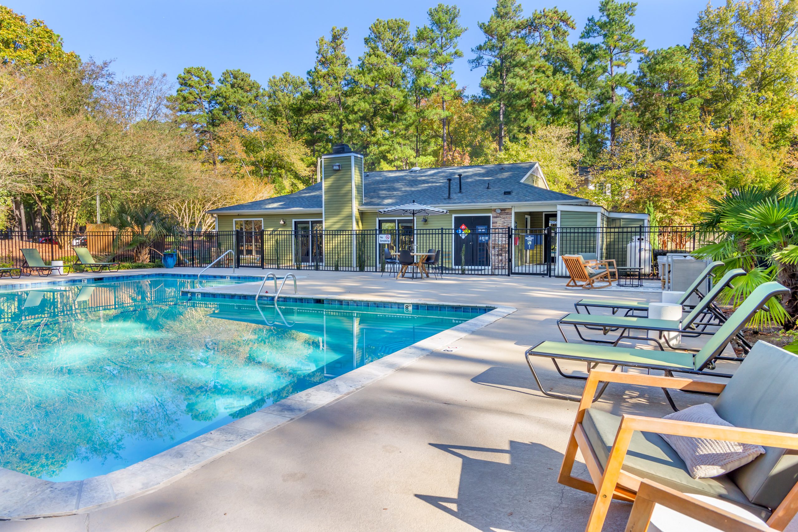 a pool with lounge chairs and a grill at The  Sawyer