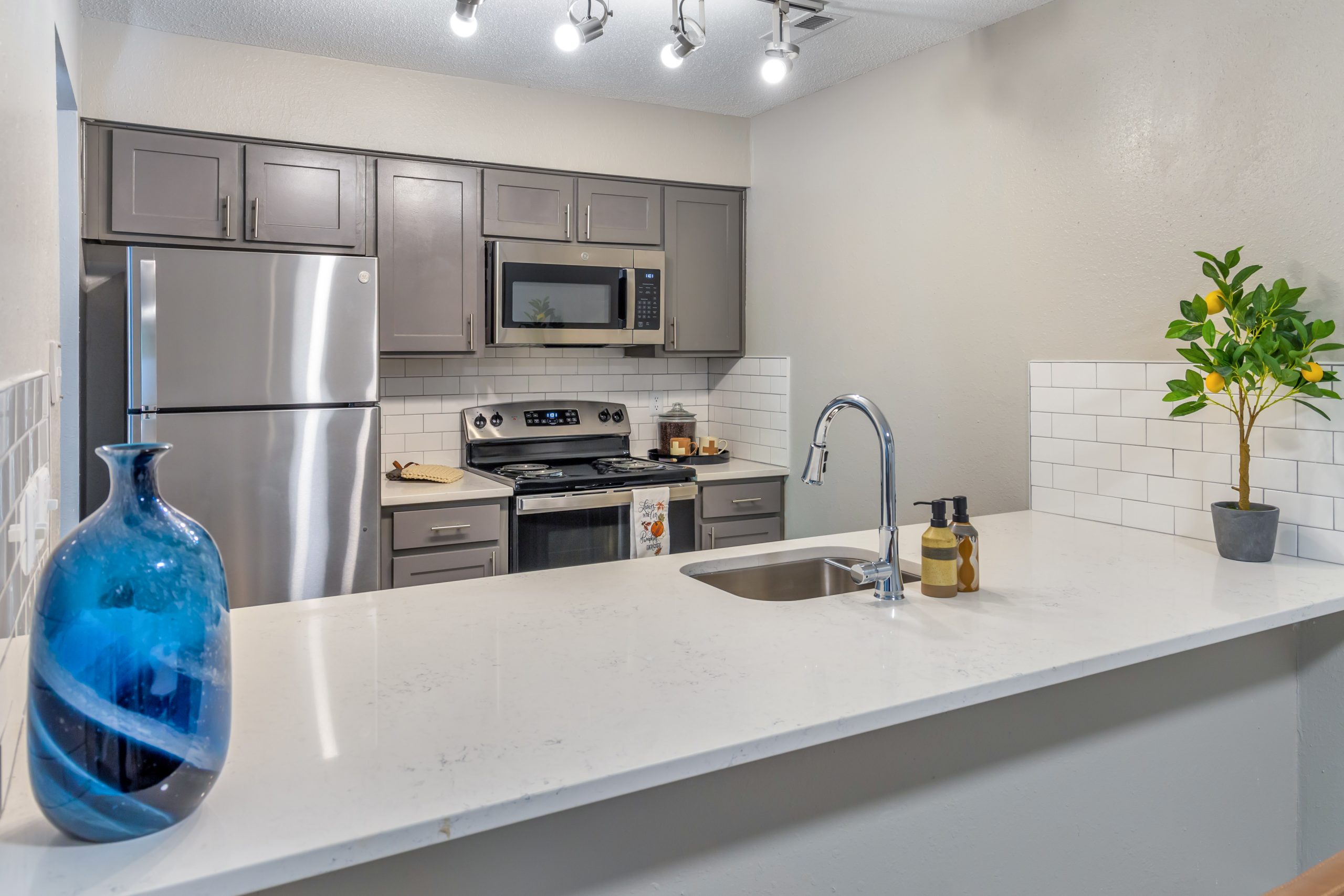 a kitchen with stainless steel appliances and a sink at The  Sawyer