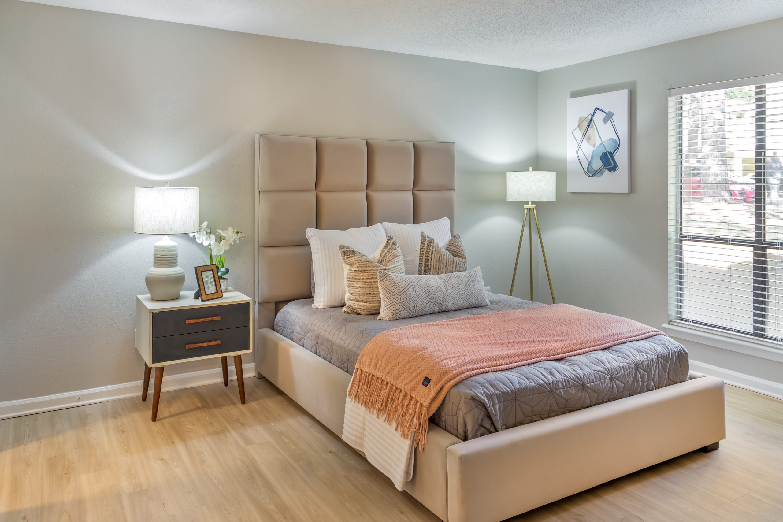 a bedroom with a bed, nightstands and a lamp at The  Sawyer